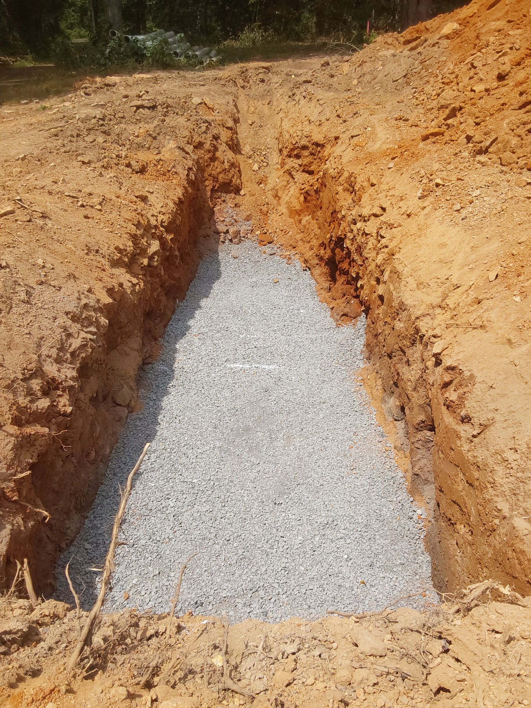a pile of gravel is sitting in a hole in the ground