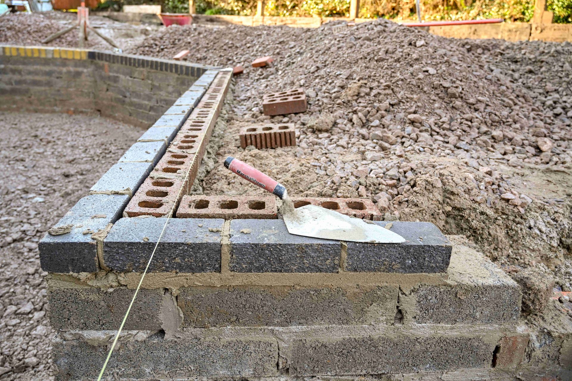 a trowel is sitting on top of a brick wall