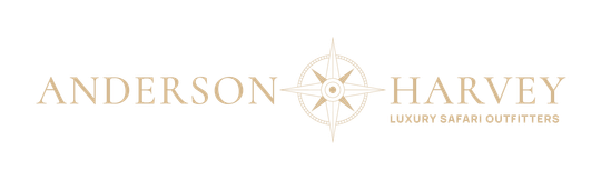 The Anderson Harvey luxury safari outfitters logo, featuring text on either side of a gold compass rose graphic.