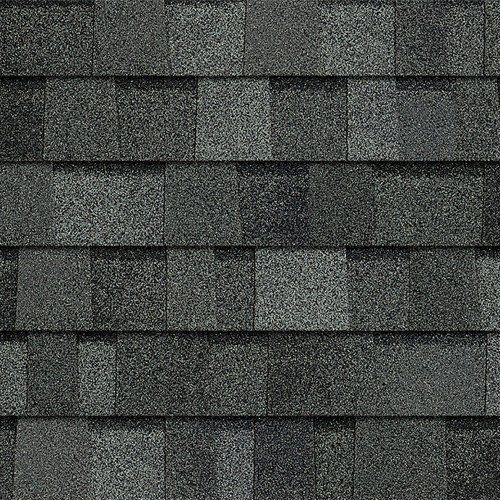 Gray asphalt shingles on a roof, shown in a close-up texture pattern.