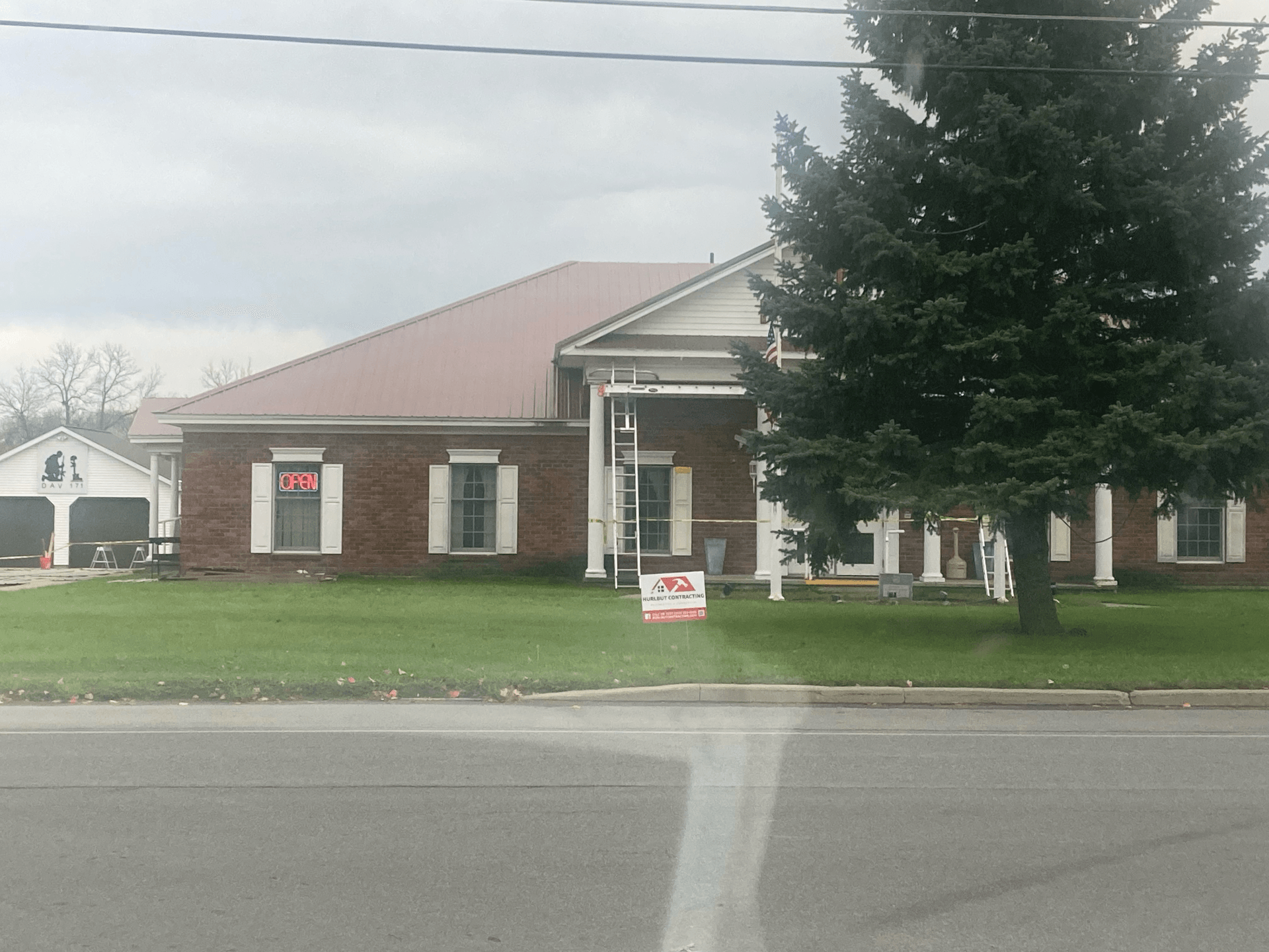 A house with a for sale sign in front of it