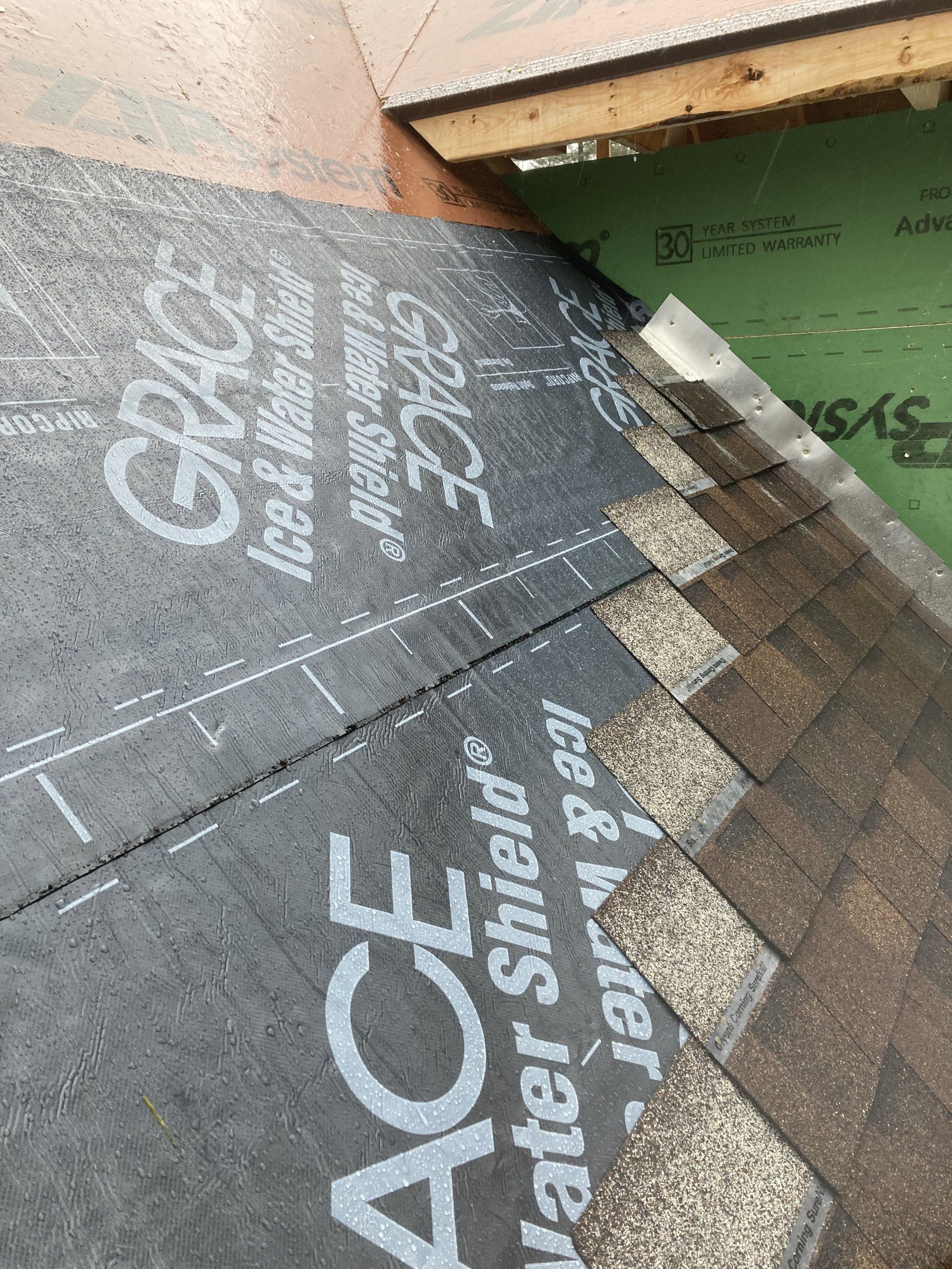 Roof underlayment with gray shingles and green wall, showing “Water Shield” and “Grace Ice & Water Shield” text