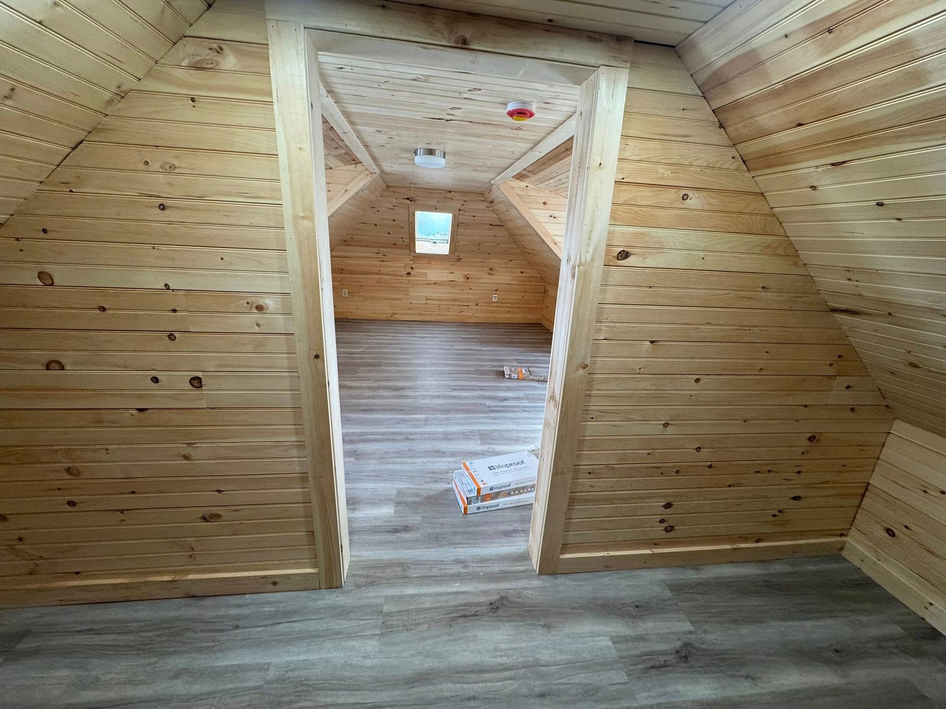 A wooden deck is being built in front of a house.