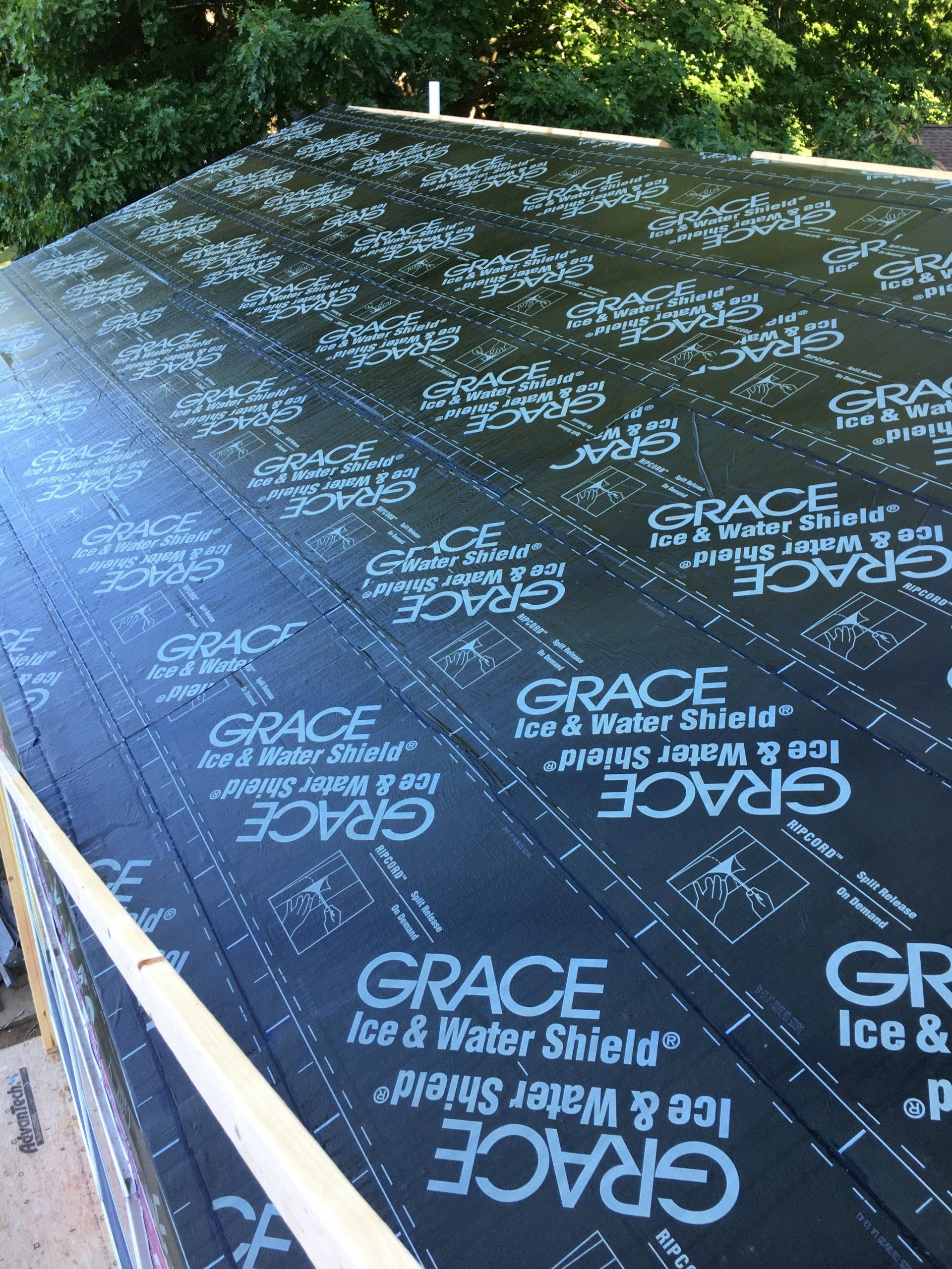 Black roof underlayment with repeated GRACE branding, viewed outdoors in daylight