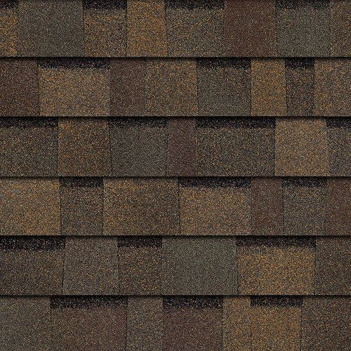 Close-up of brown and gray roof shingles with a weathered texture.