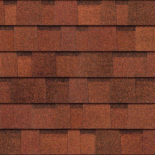 Close-up of reddish-brown roof shingles arranged in horizontal rows