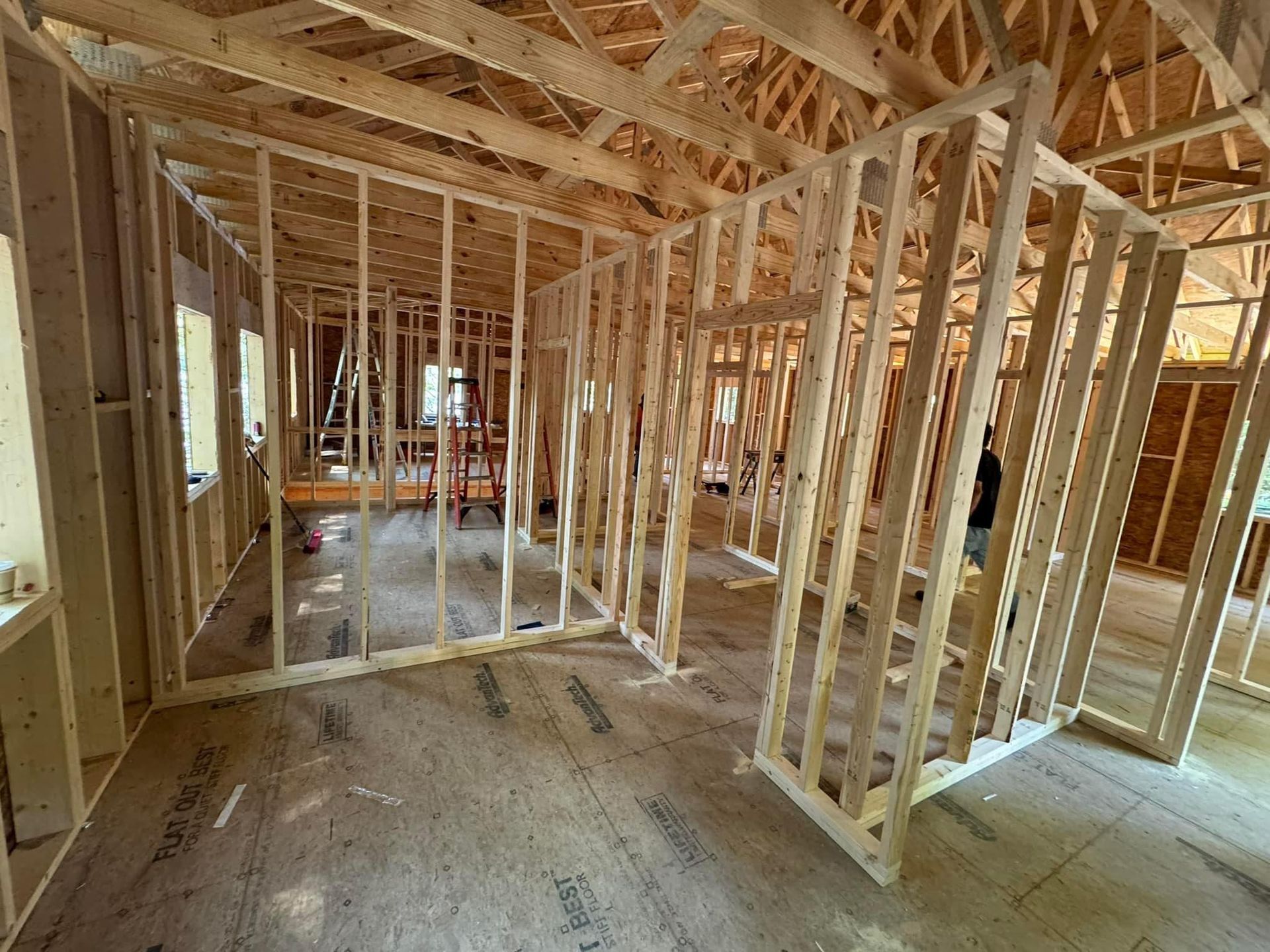 The inside of a house under construction with wooden frames.