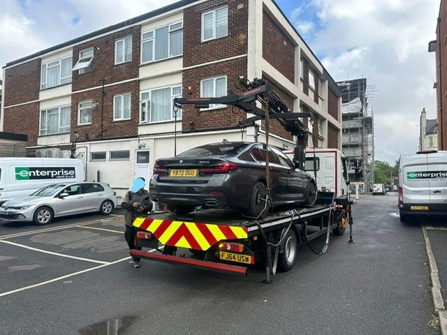 A sleek tow truck with the brand name