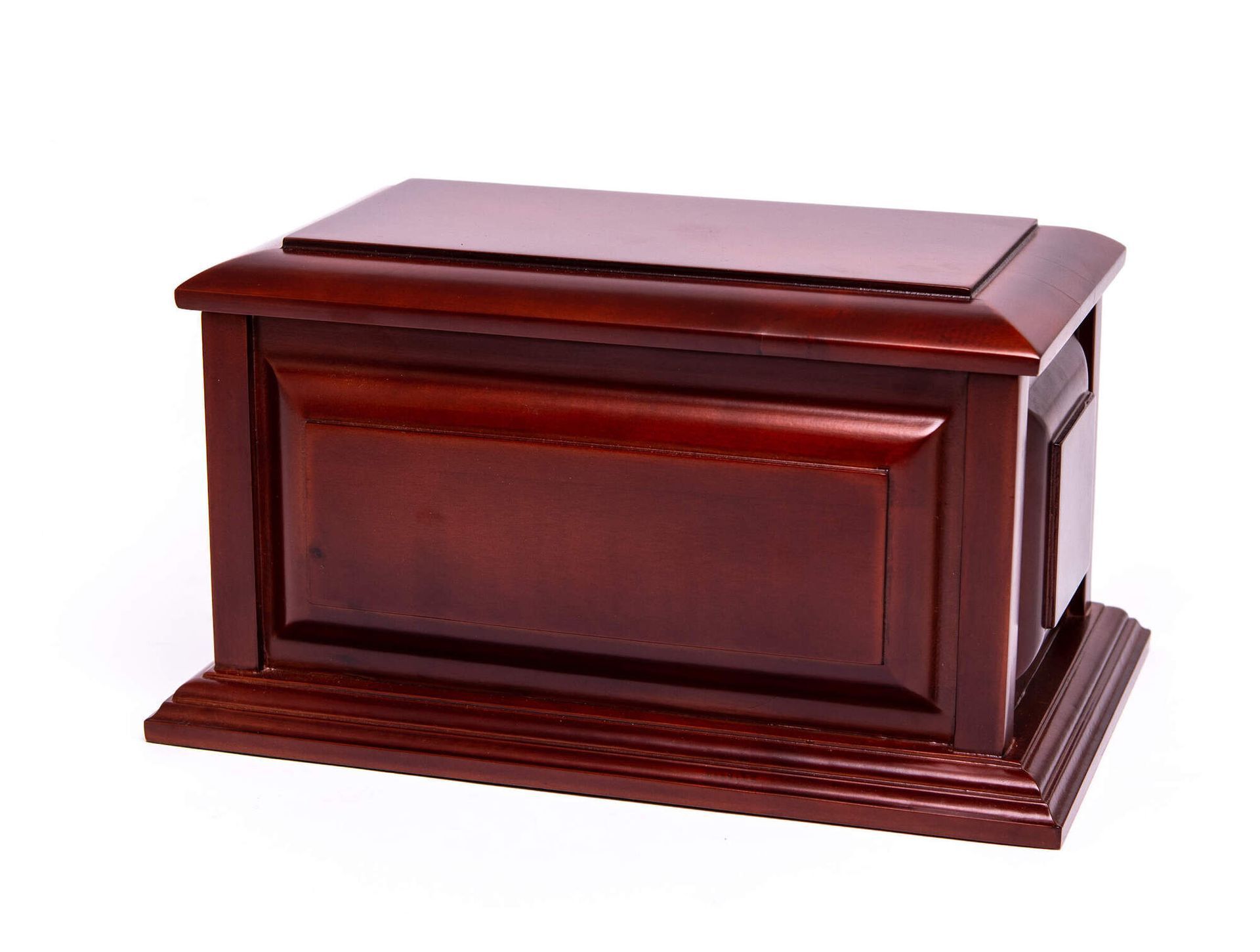 Polished dark wood coffin with a closed lid and decorative base on a white background