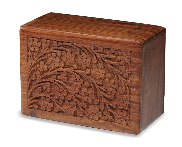 Small carved wooden box with ornate floral pattern on the front panel