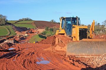 A bulldozer is moving dirt on a construction site.