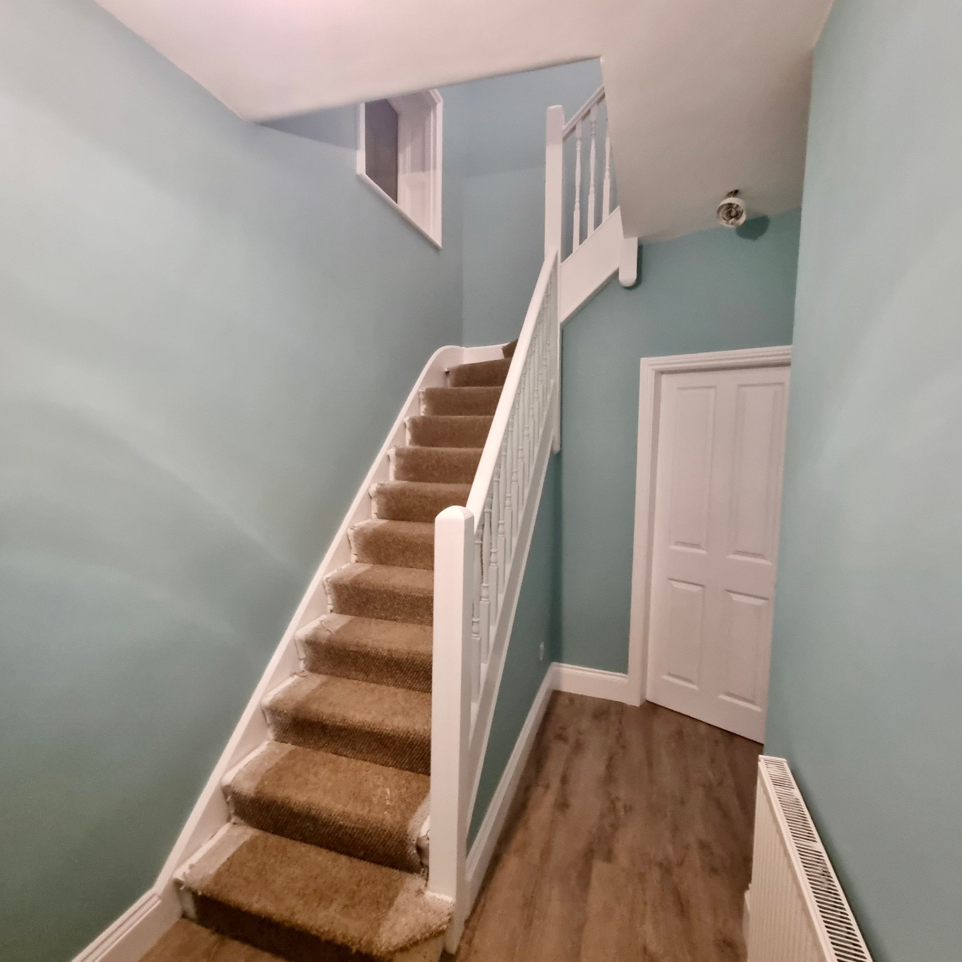 Beautifully painted staircase with light blue walls creating a fresh look in York.