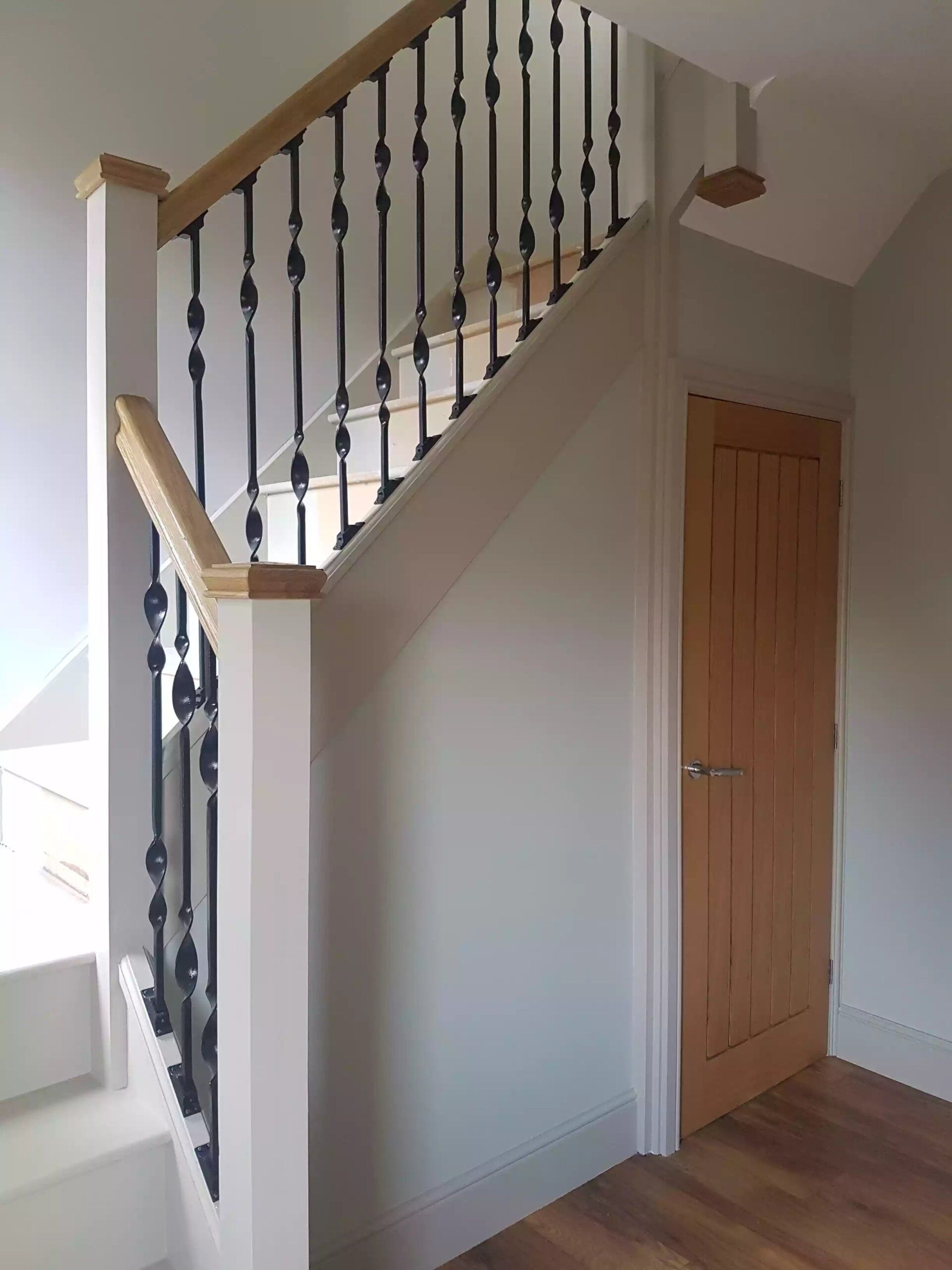 Renovated wooden staircase with sleek black railings and a modern look in York.