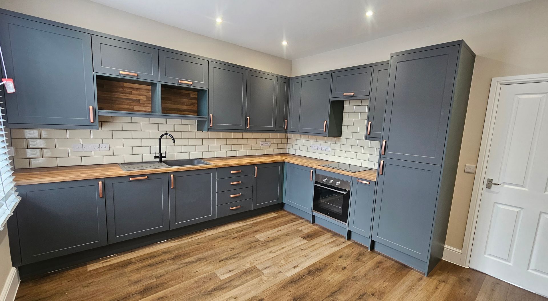 Modern painted kitchen with navy cabinets and off-white walls in York.