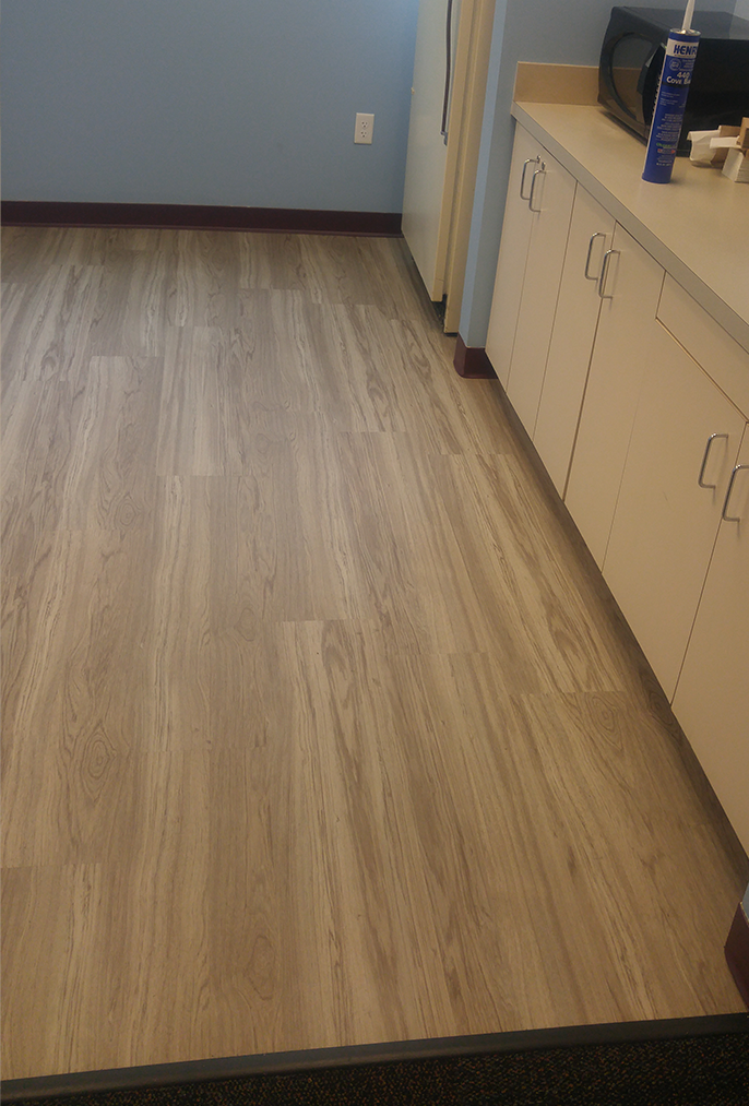 Wood-look commercial flooring after replacement