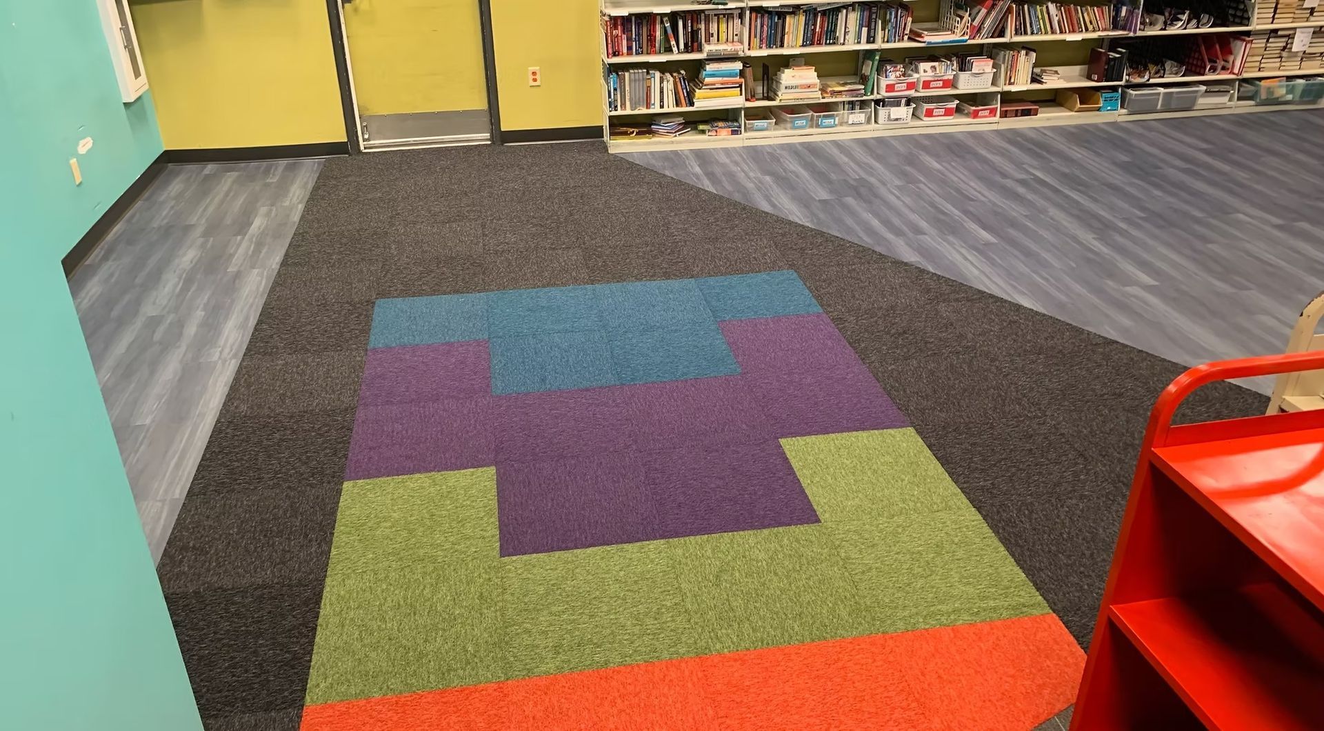 Colorful geometric carpet tile design in a school library