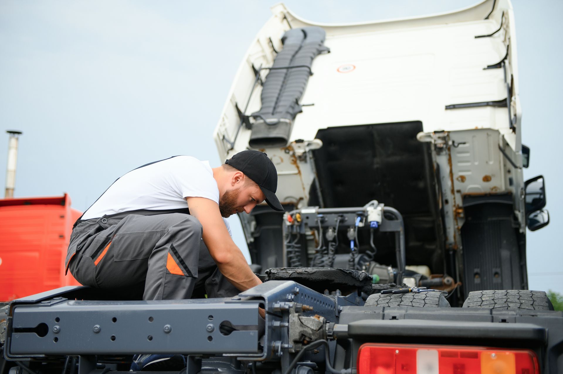 Mechanic repairing the truck in service.