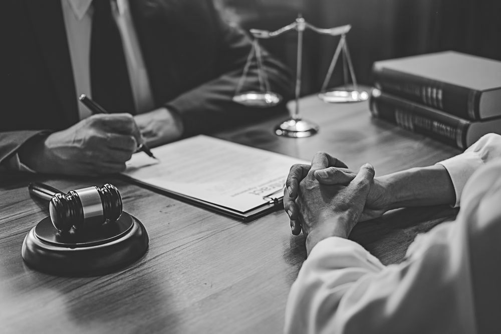 Criminal Law Book On A Wooden Table With A Gavel — Farrell Lusher Solicitors In Wagga Wagga, NSW