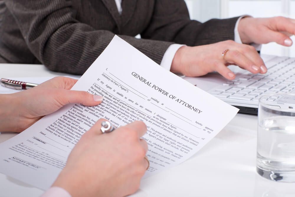 Hands Of The Woman Signing A Documents — Farrell Lusher Solicitors In Wagga Wagga, NSW