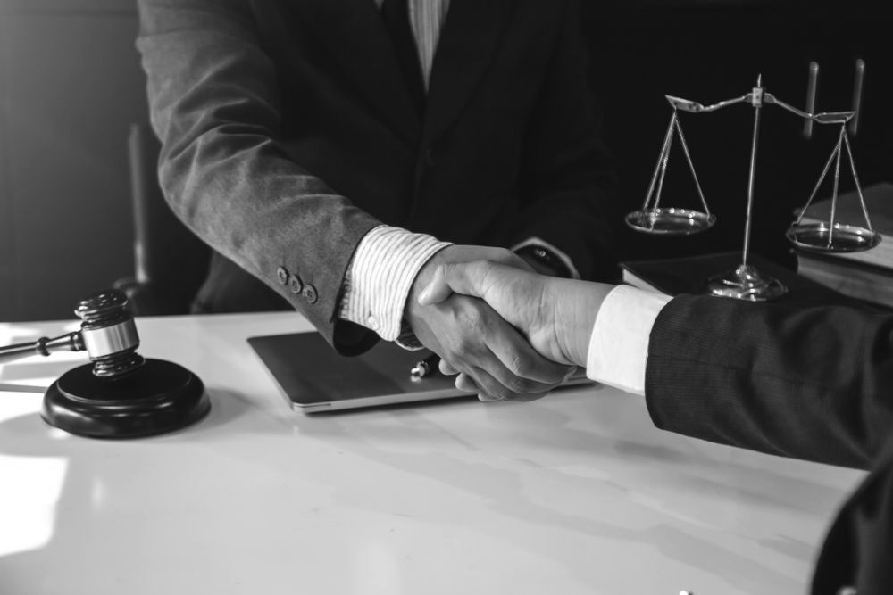 A Man Explaining With A Pen In Right Hand To Other Man — Farrell Lusher Solicitors In Wagga Wagga, NSW
