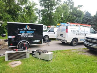HVAC ductwork in an attic with flexible insulated ducts connected to metal boxes. 