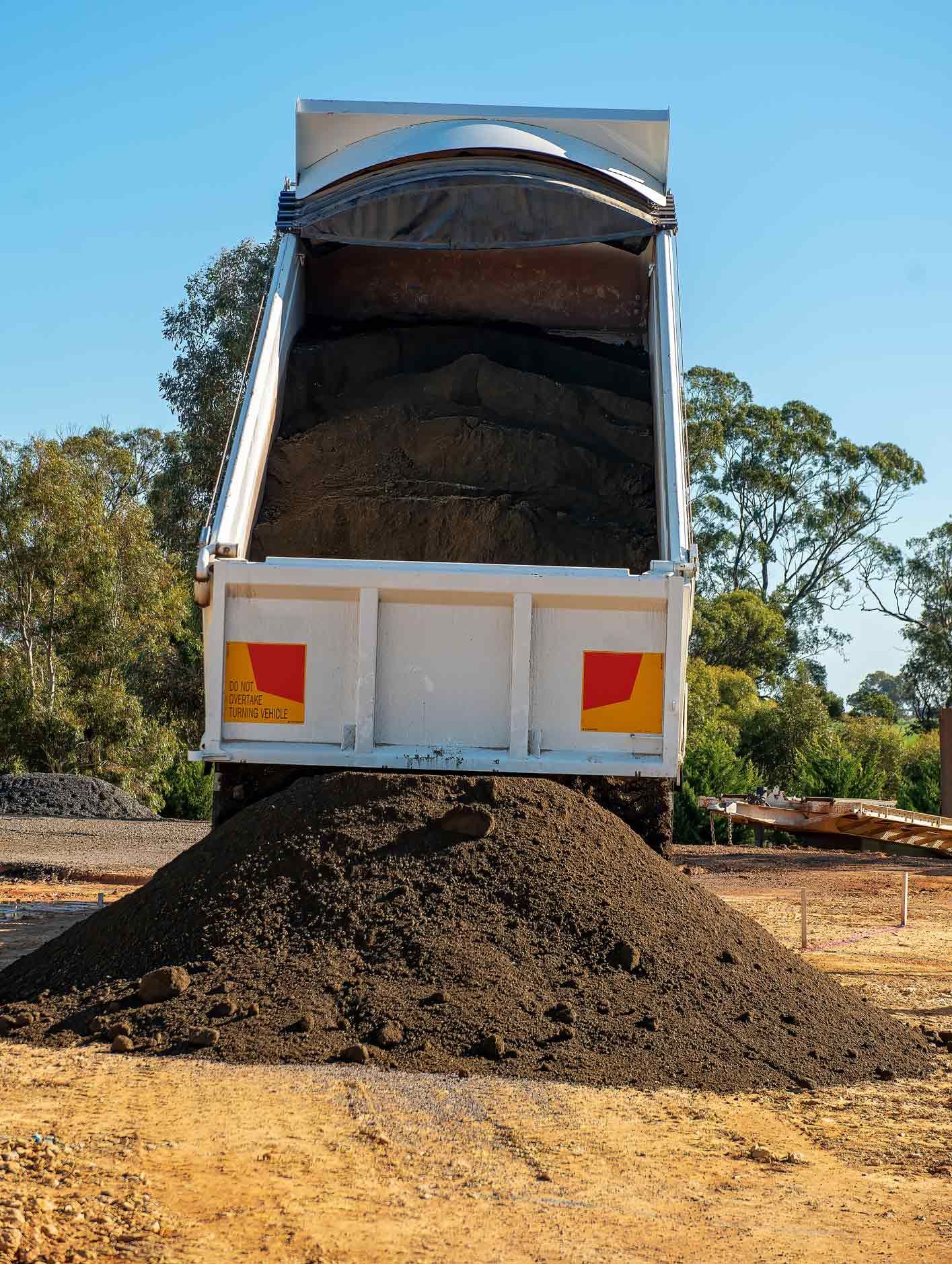 Dump truck unloading crushed gravel | Bundoora, VIC | Mercuri Garden & Building Supplies