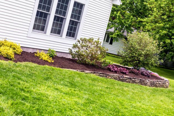 New mulch delivery includes compost manure behind elegant garden terrace retaining wall.