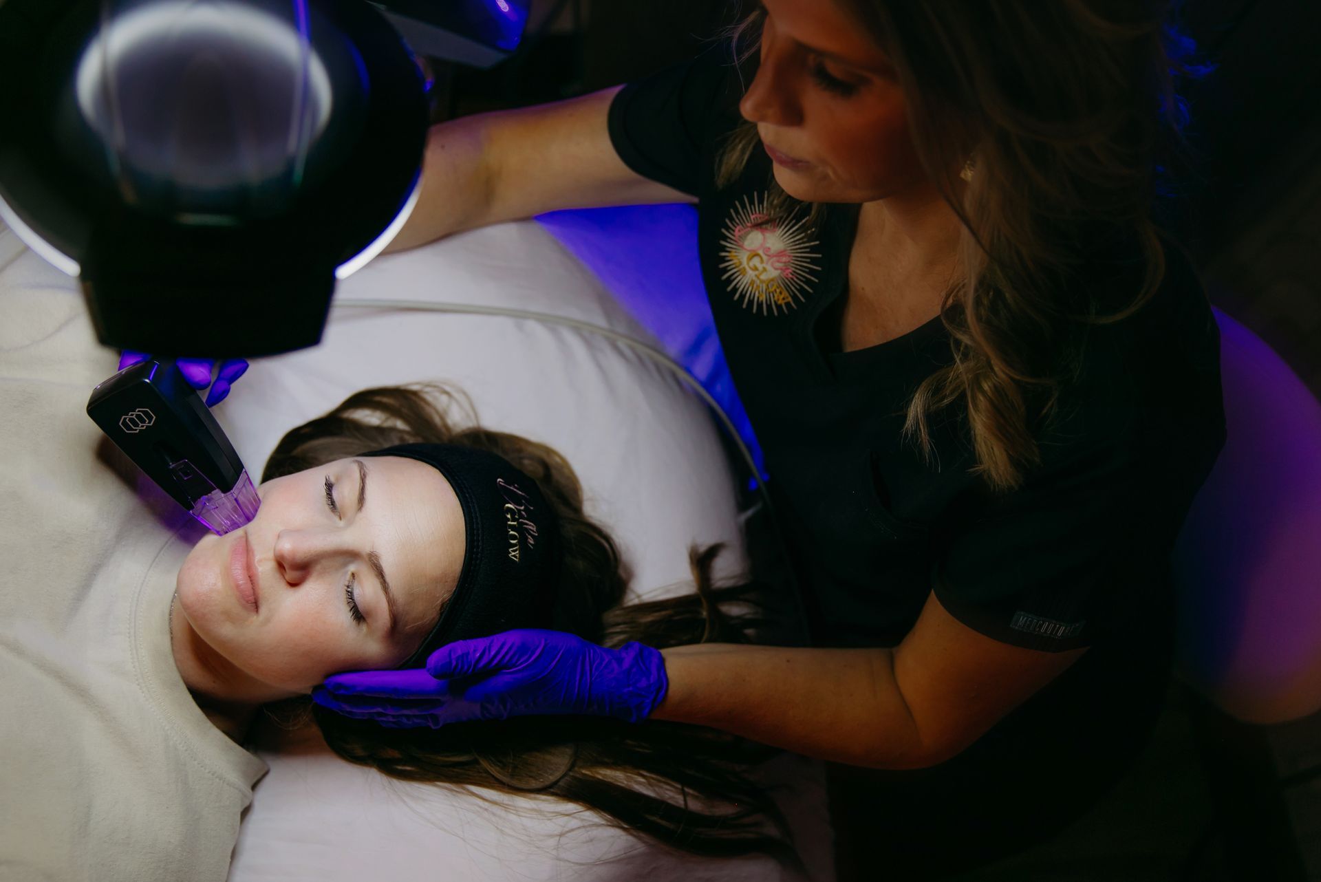 A woman is getting a facial treatment at a beauty salon.