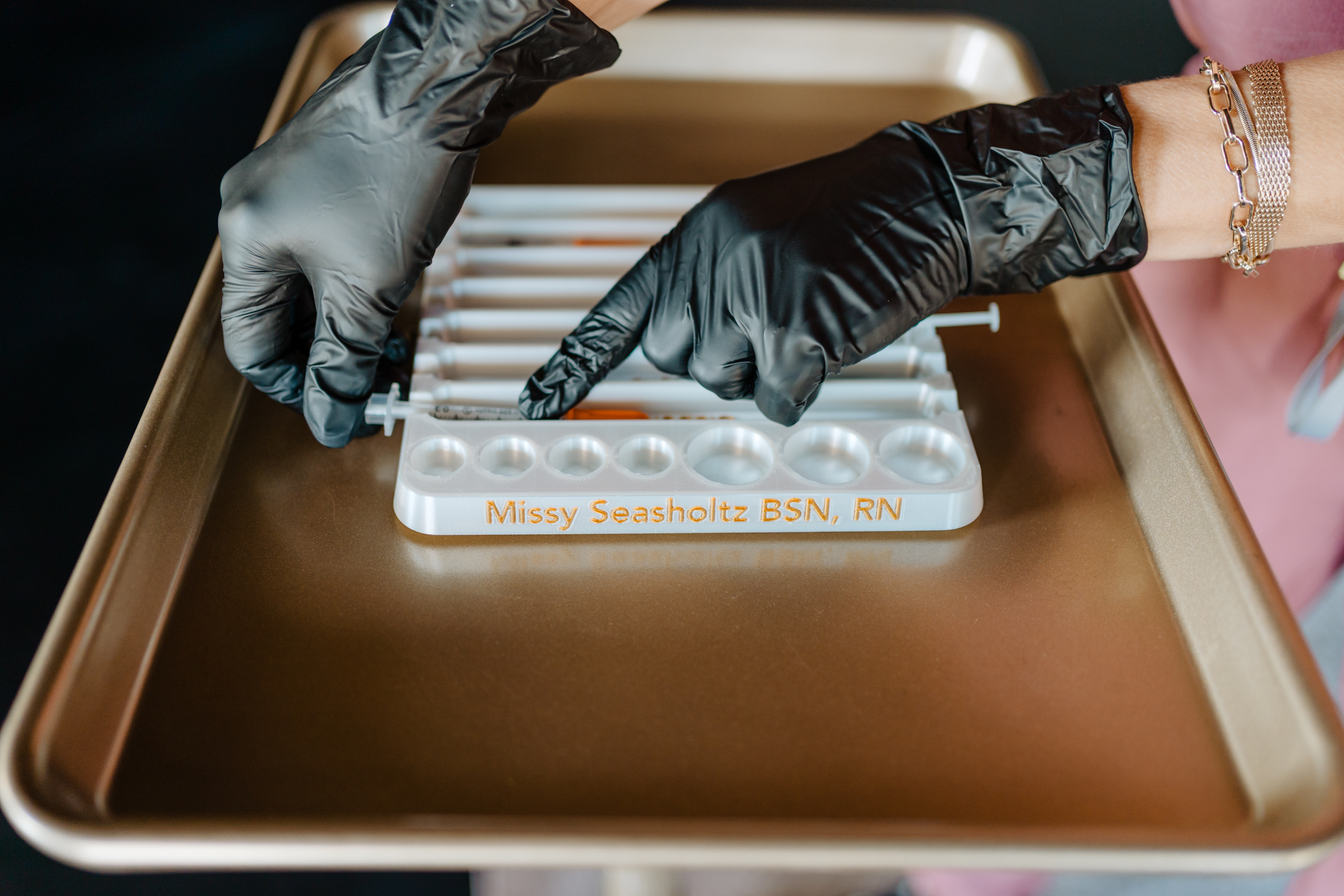 A woman is getting a botox injection in her eye.