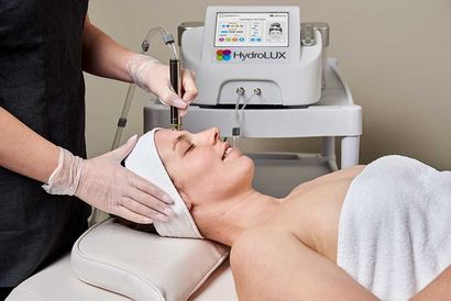 A Person is Holding a Bottle of the Skincare Company Hydration Booster — Renew Laser Clinic in Taree, NSW