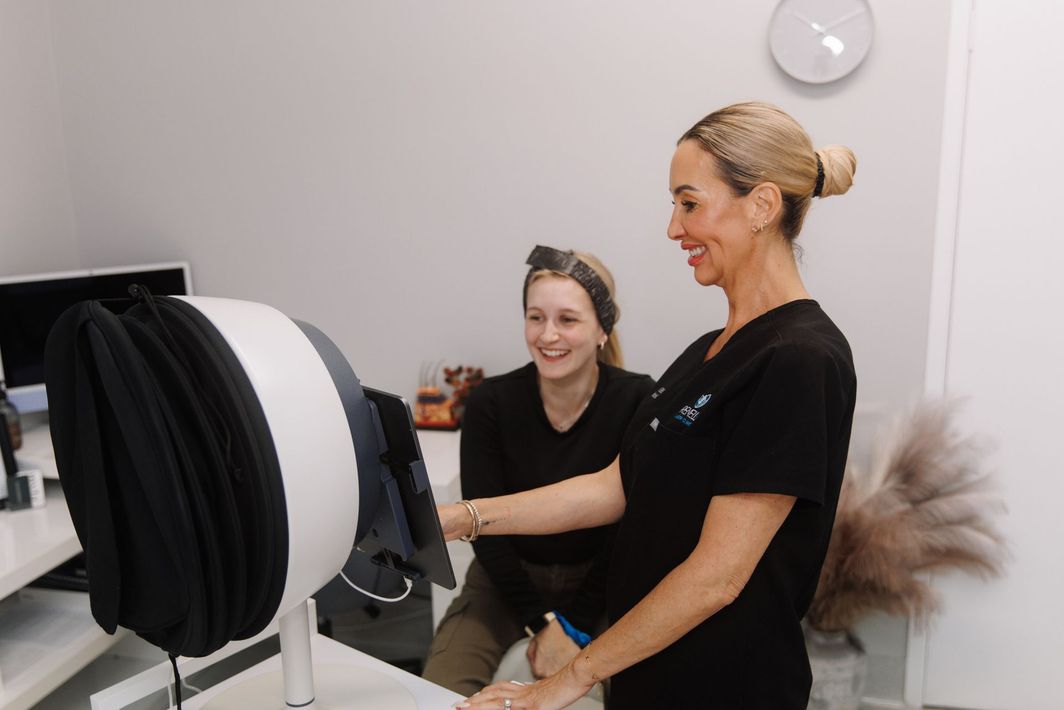 A Woman With a Black Mask on Her Face is Getting a Treatment — Renew Laser Clinic in Taree, NSW