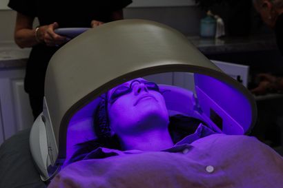 A Person is Laying on a Bed in a Room With a Machine — Renew Laser Clinic in Taree, NSW