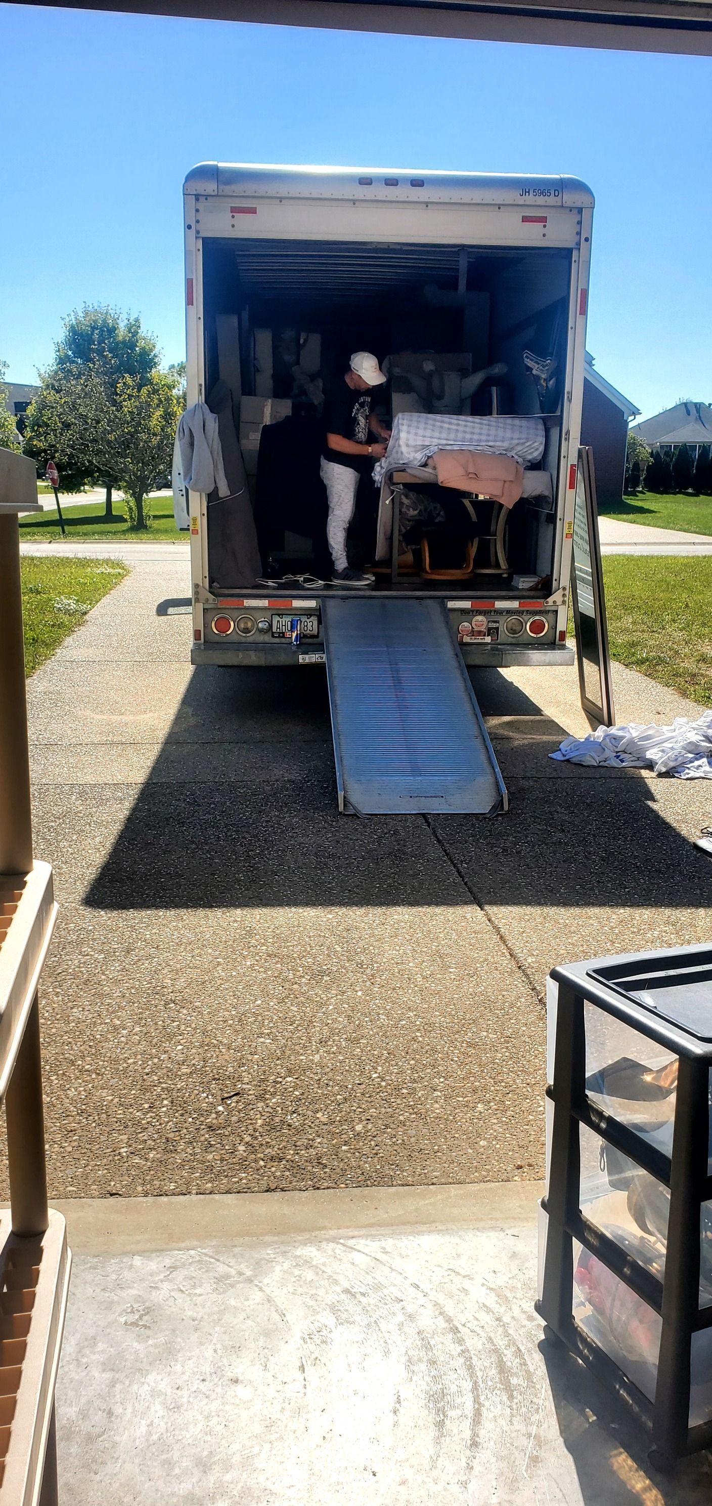 A man is loading furniture into a moving truck.