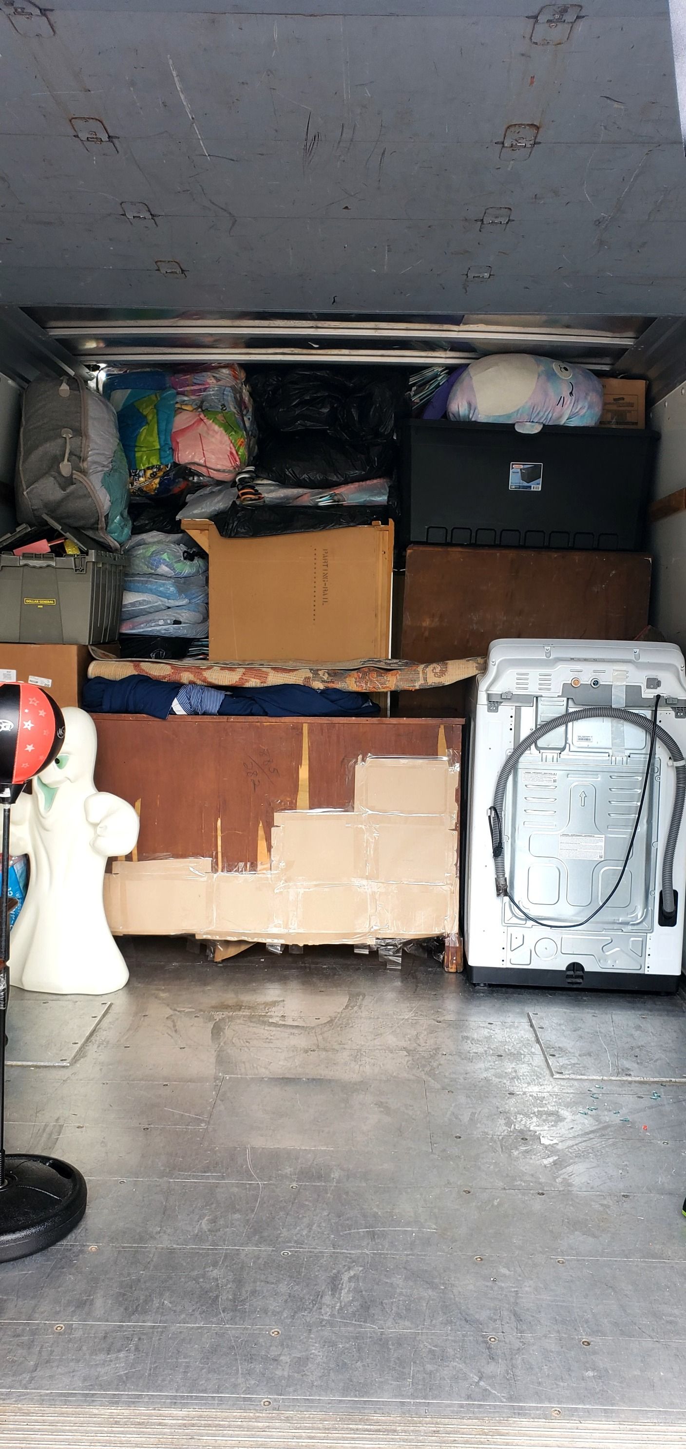 A van is filled with lots of boxes and appliances.
