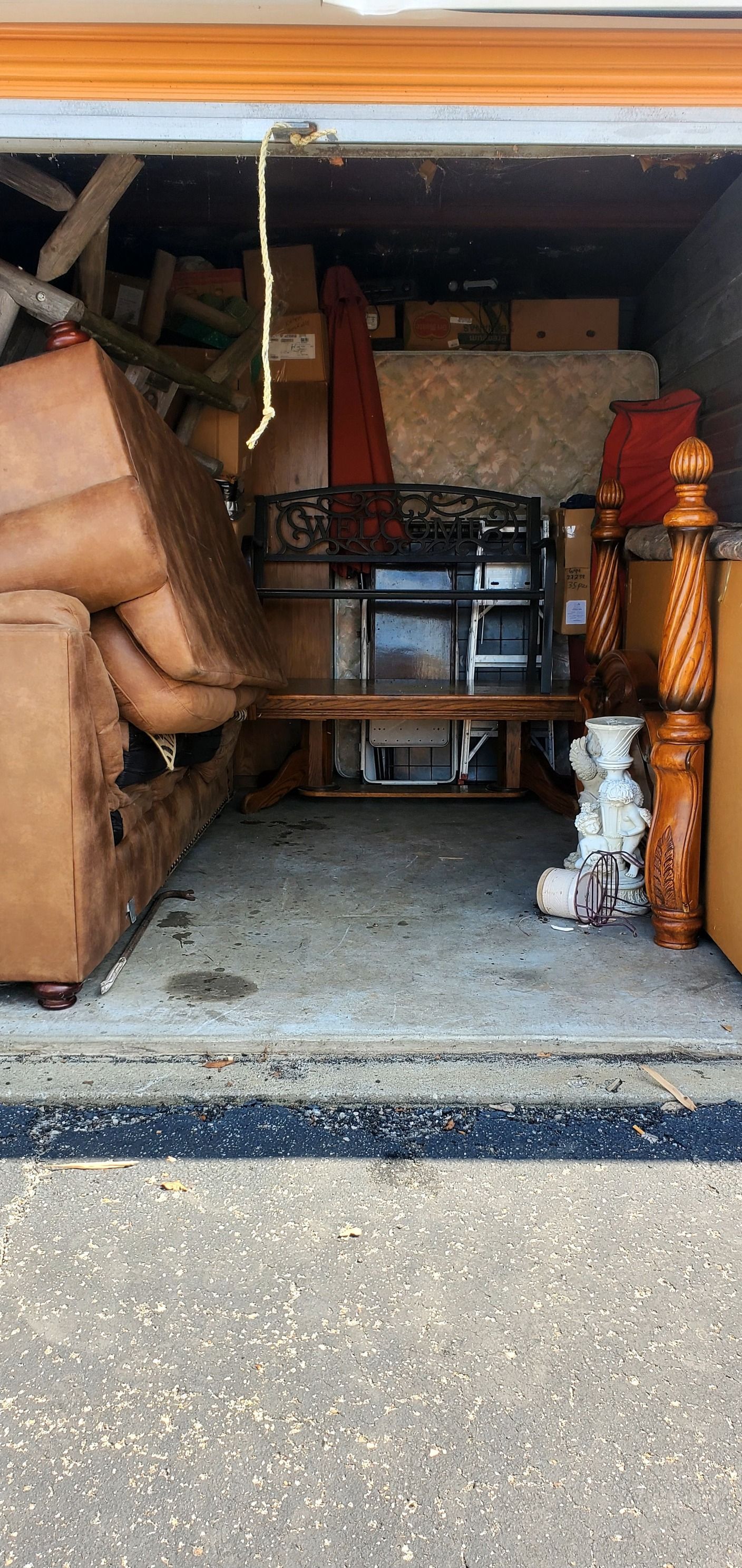 A garage filled with lots of furniture and boxes.