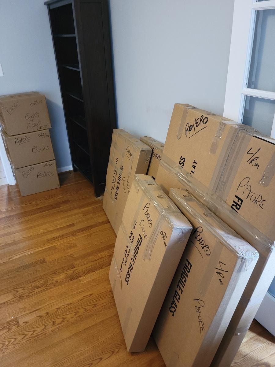 A bunch of cardboard boxes are stacked on top of each other in a room.