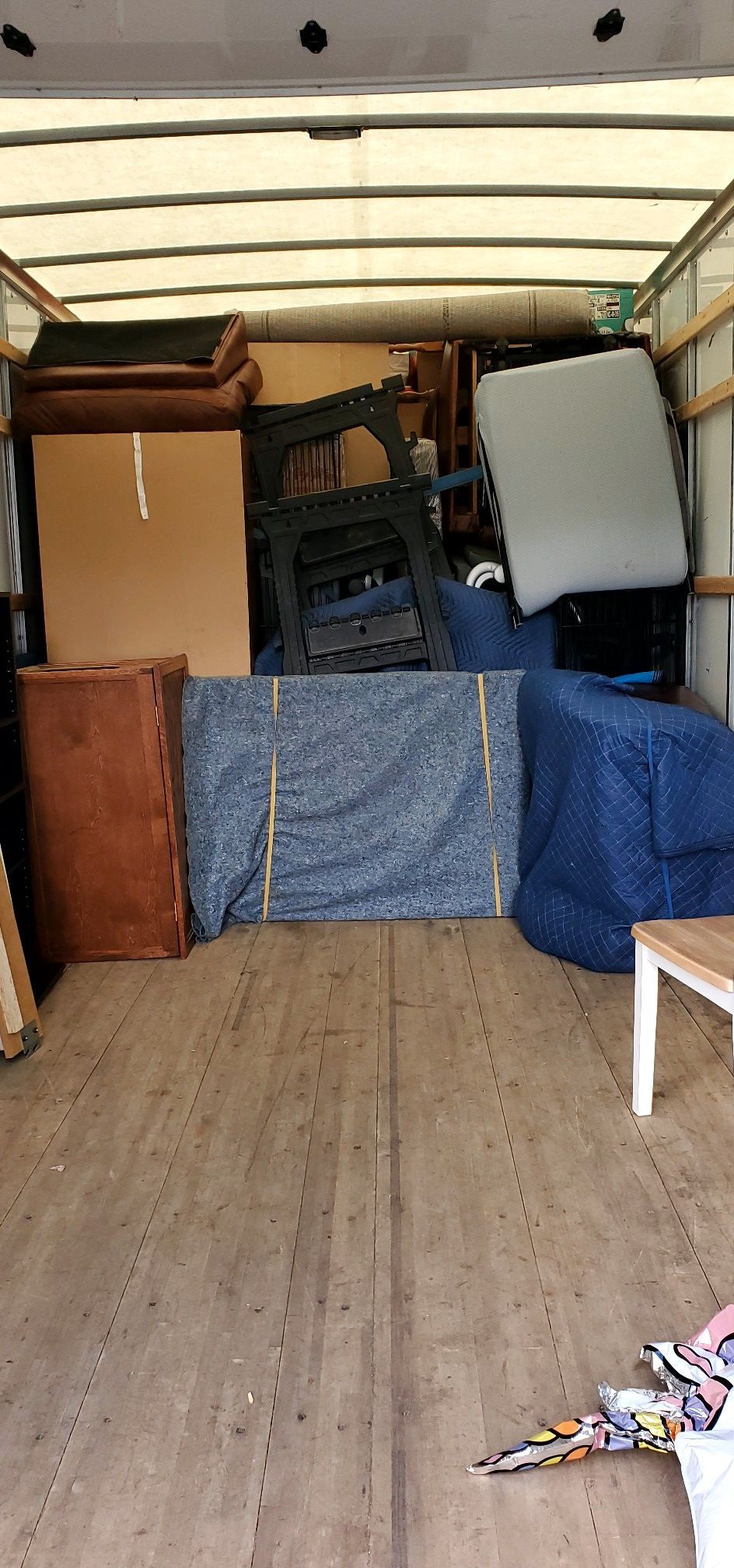 The inside of a moving truck filled with lots of furniture.