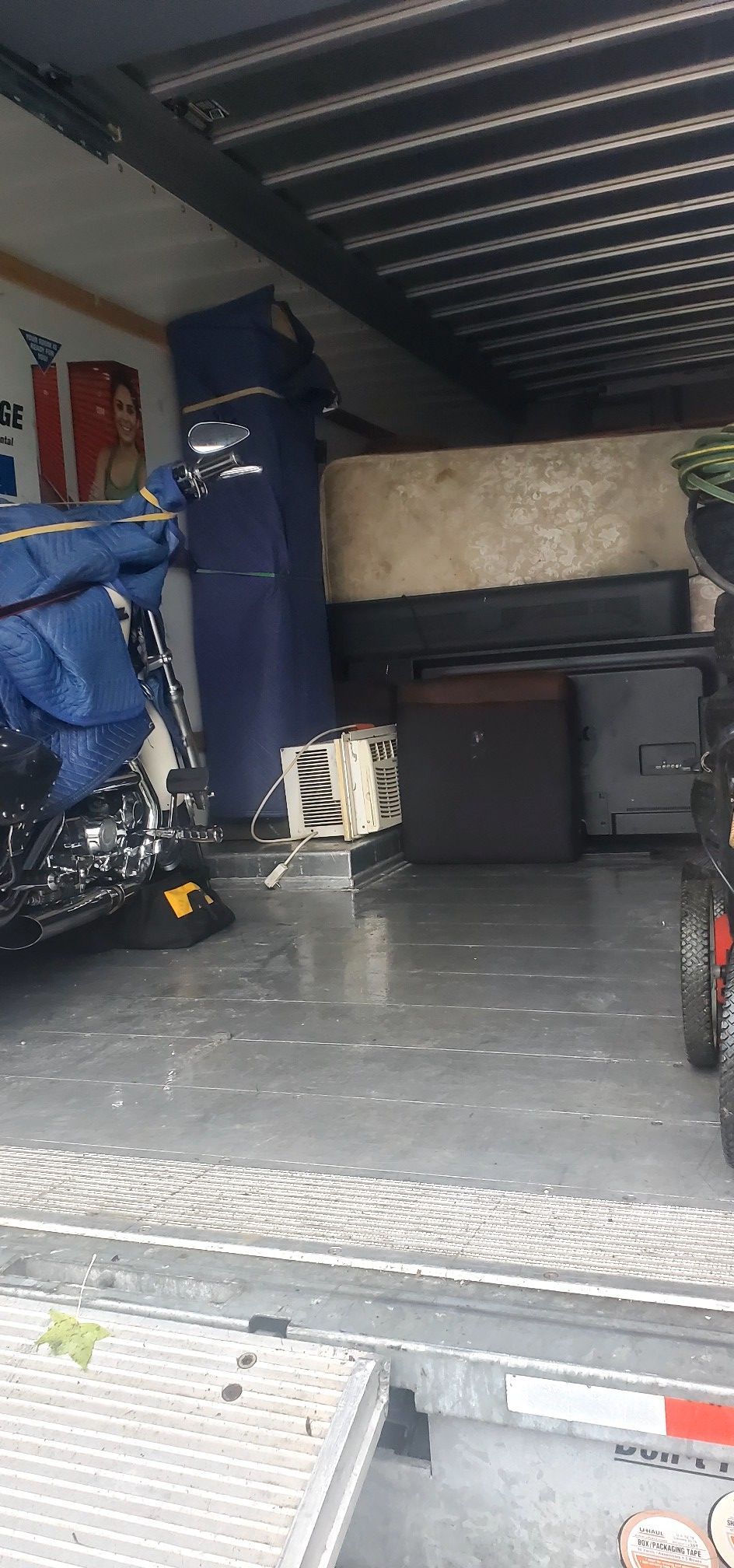 A motorcycle is parked in the back of a truck.