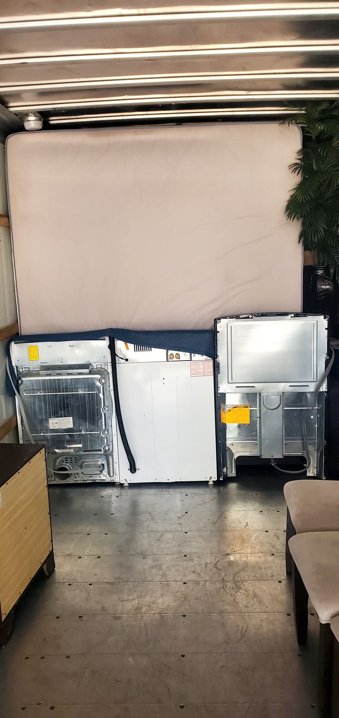 A refrigerator is sitting in the back of a truck.