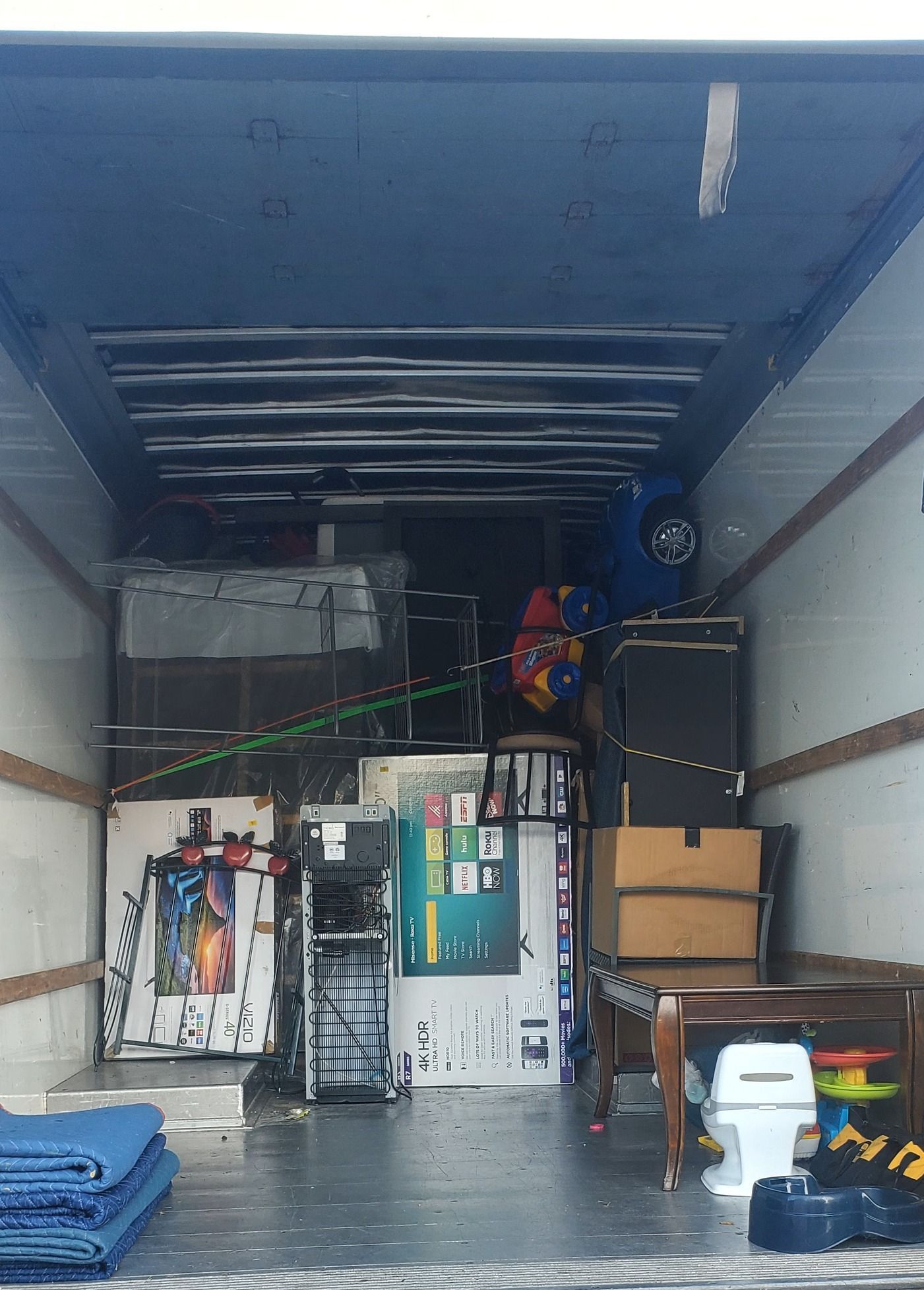 The inside of a moving truck filled with lots of furniture.