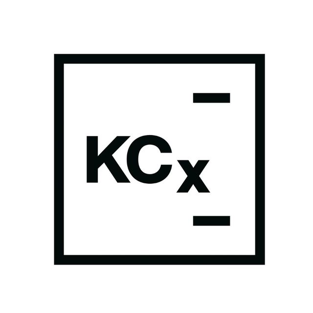 Black KCx logo inside a square outline with two short horizontal bars on the right