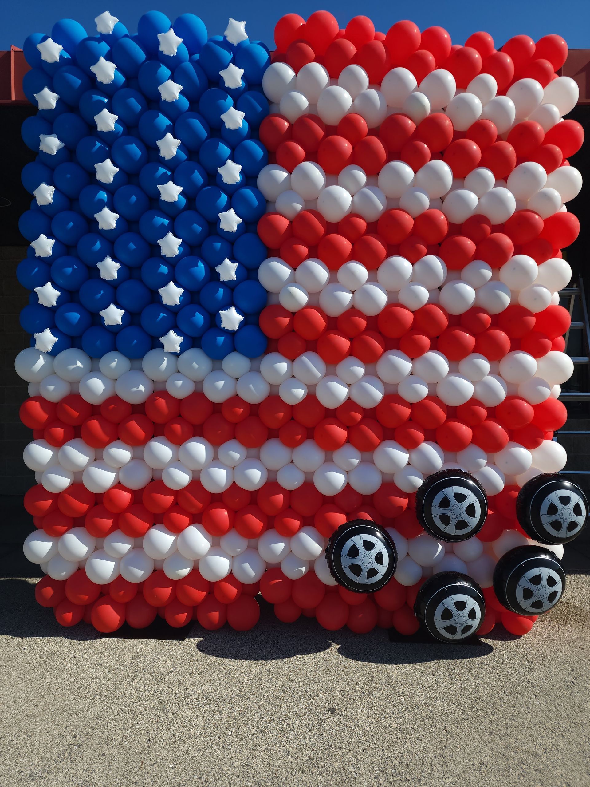 An american flag made of red white and blue balloons