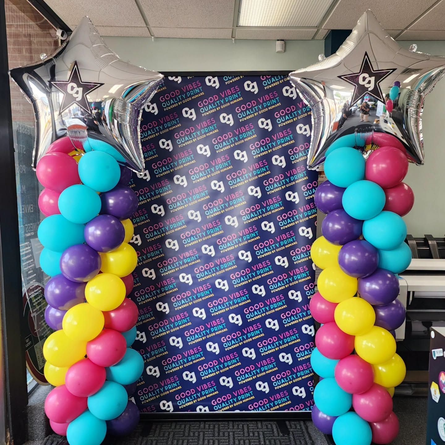 A thank you balloon is surrounded by blue and yellow balloons
