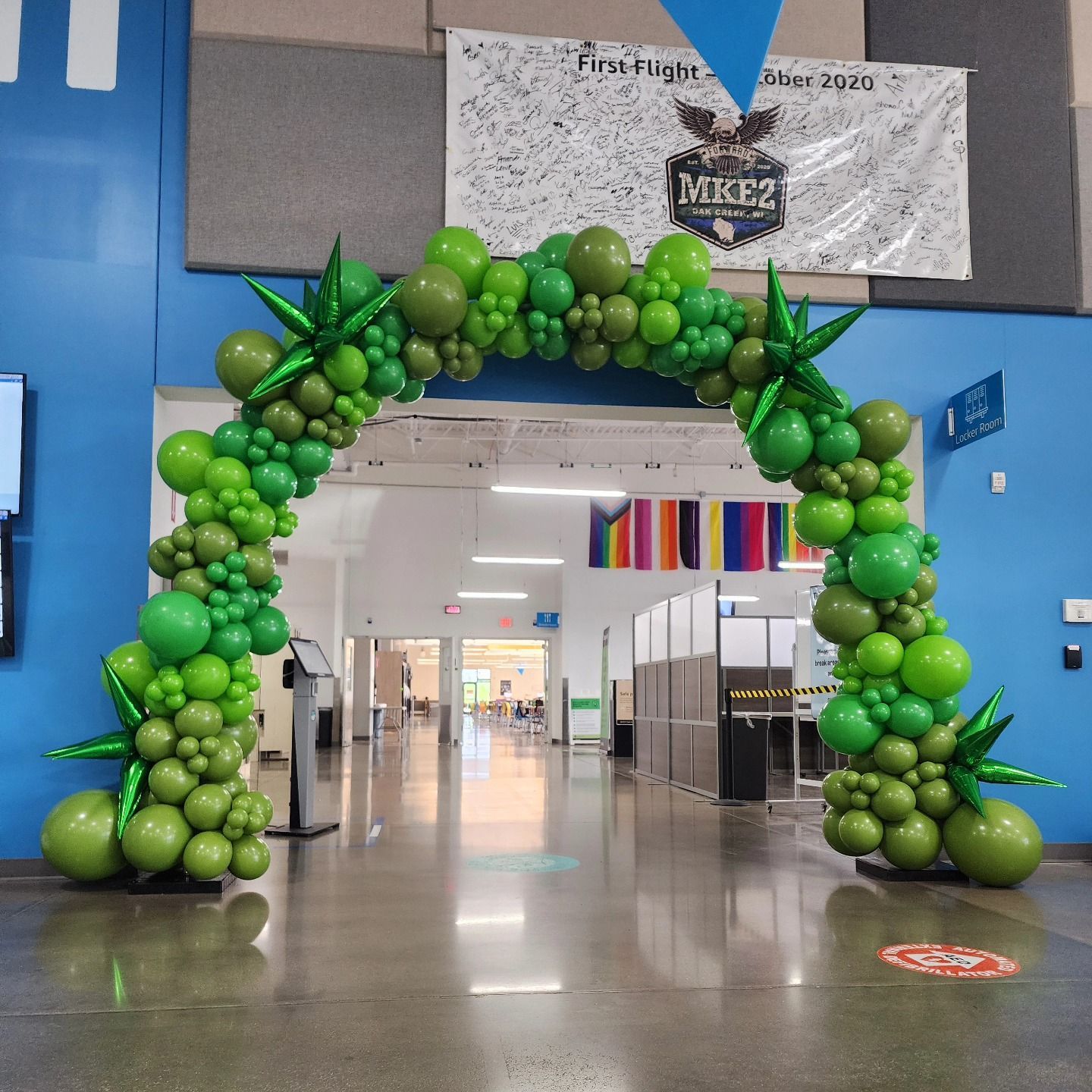 A hallway is decorated with blue and purple balloons