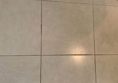 A close up of a tiled floor with a light shining on it.