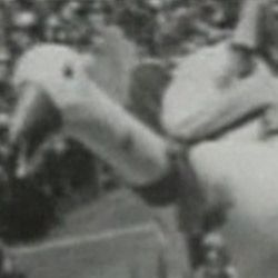 A black and white photo of a person jumping in the air.