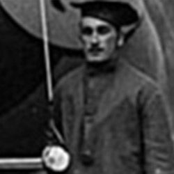 A man in a hat is holding an umbrella in a black and white photo.