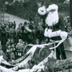 A black and white photo of santa claus in a sleigh.