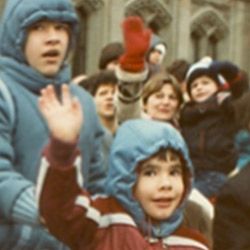A group of people wearing hooded jackets and mittens