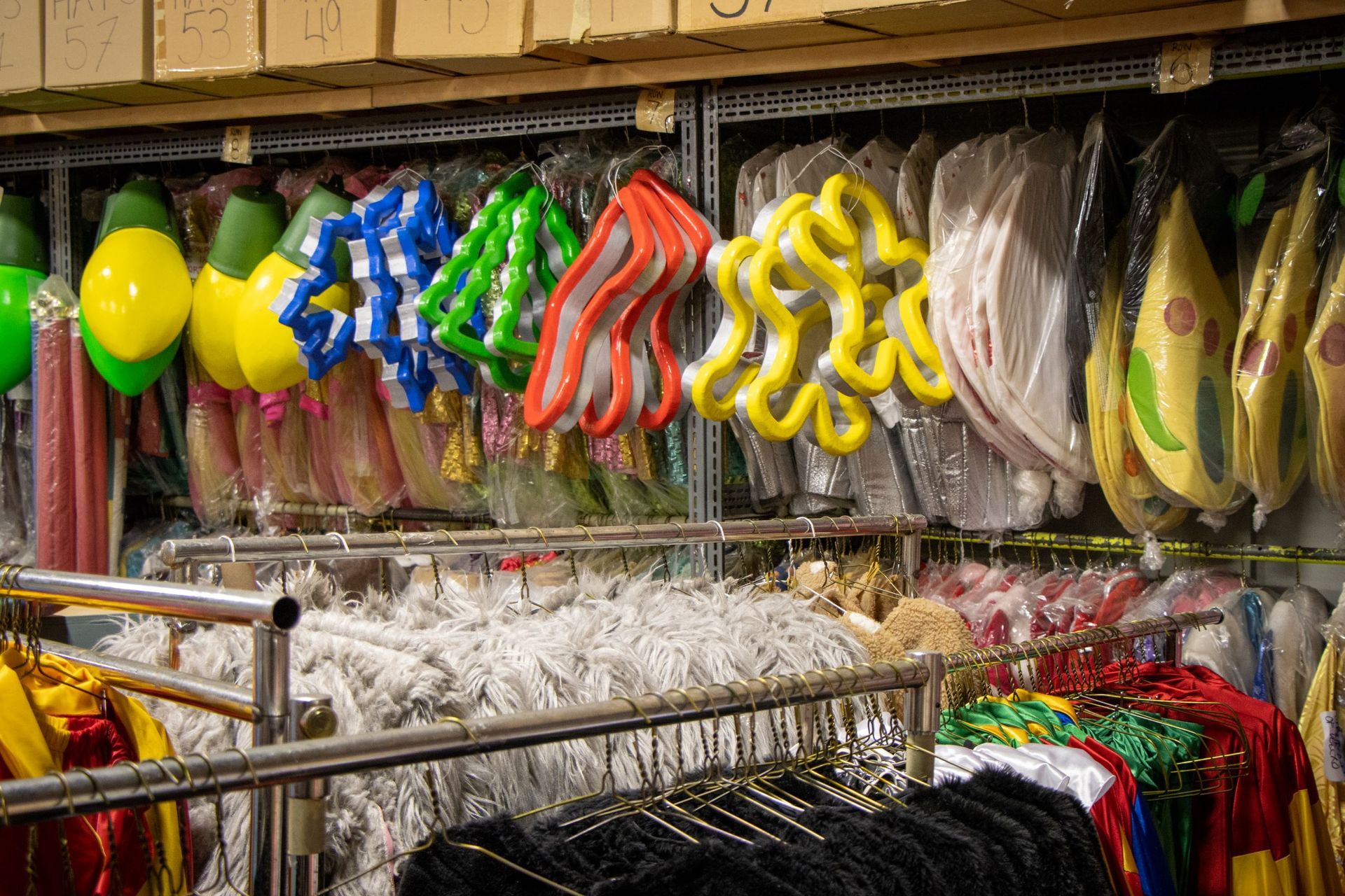 A bunch of balloons are hanging on a rack in a store